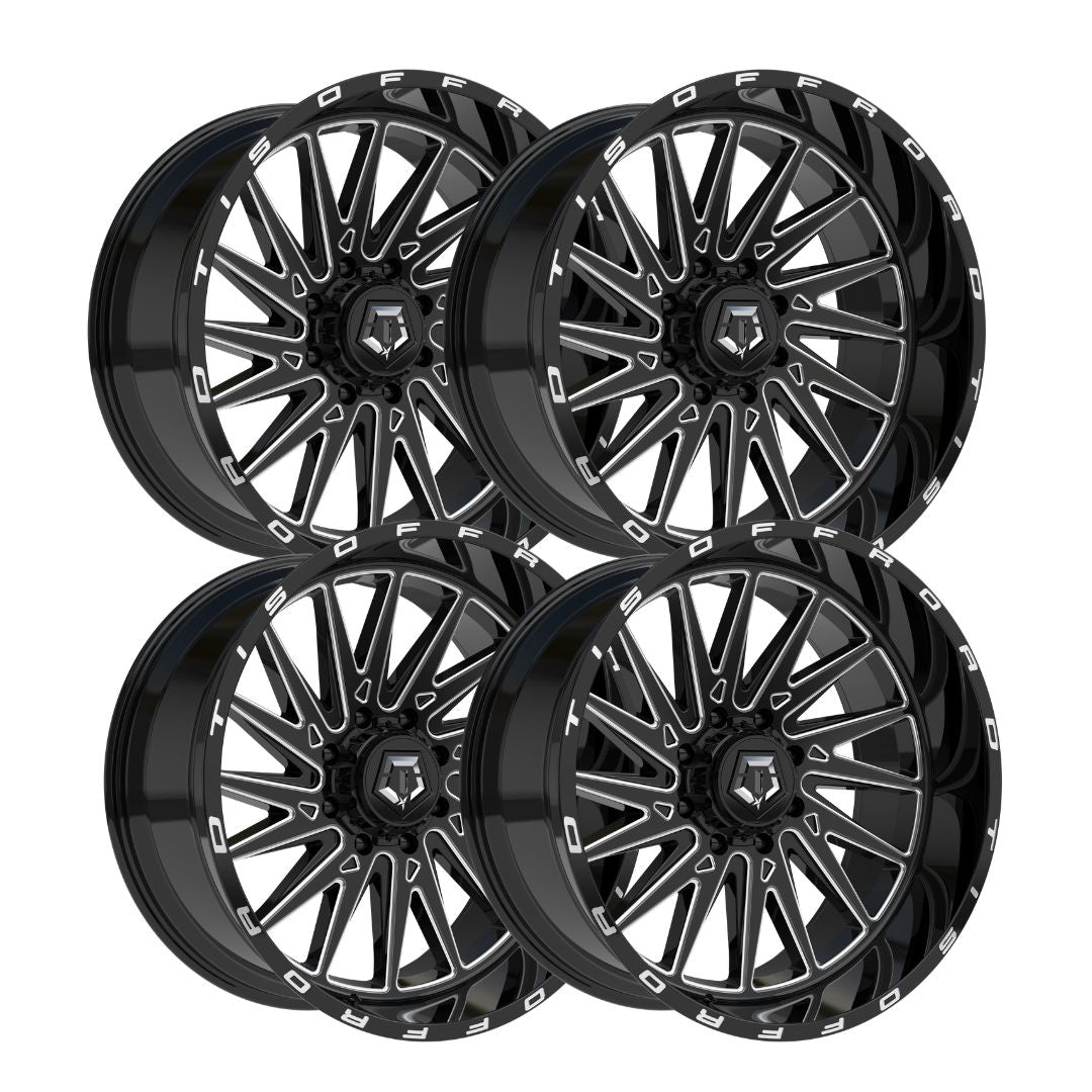 Four black multi-spoke alloy wheels arranged in a 2x2 grid on a plain white background.